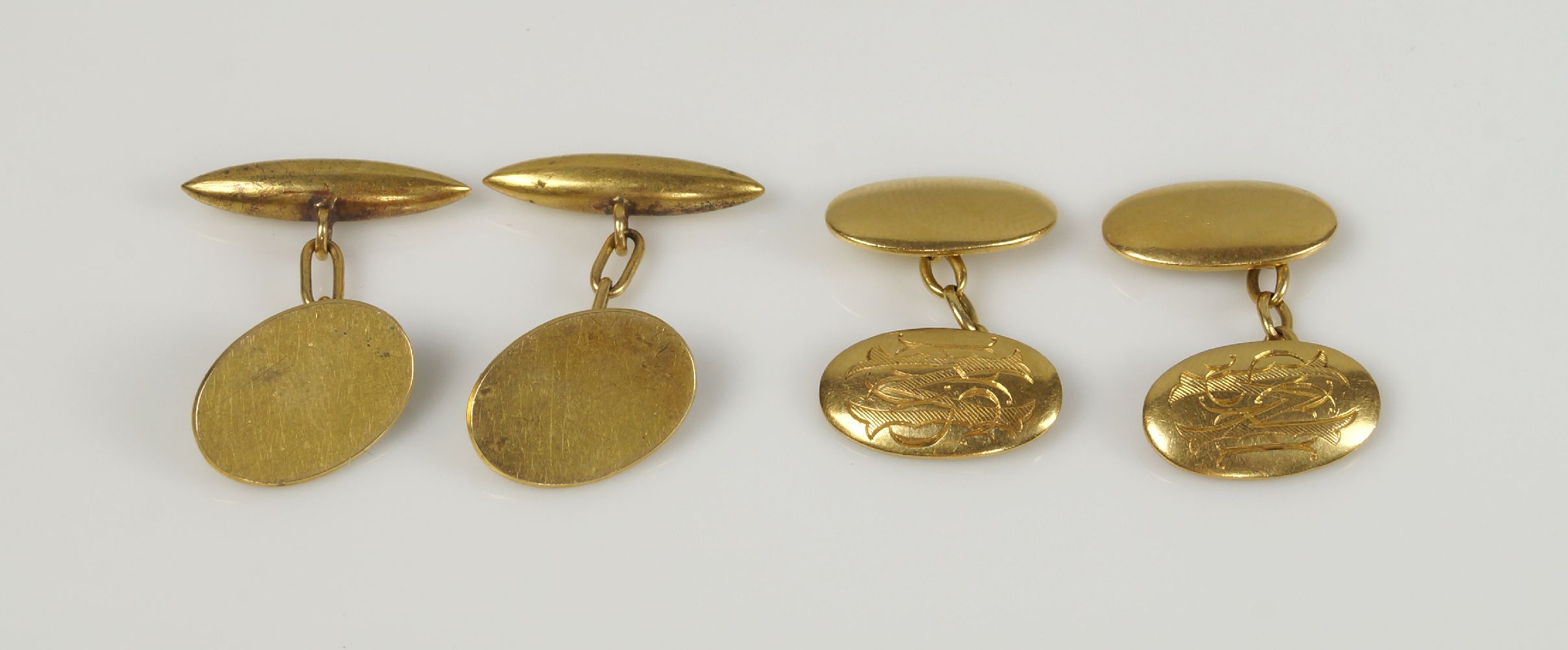 Two pairs of cufflinksComprising: a pair of 18ct. gold oval domed panels with engraved monogram,