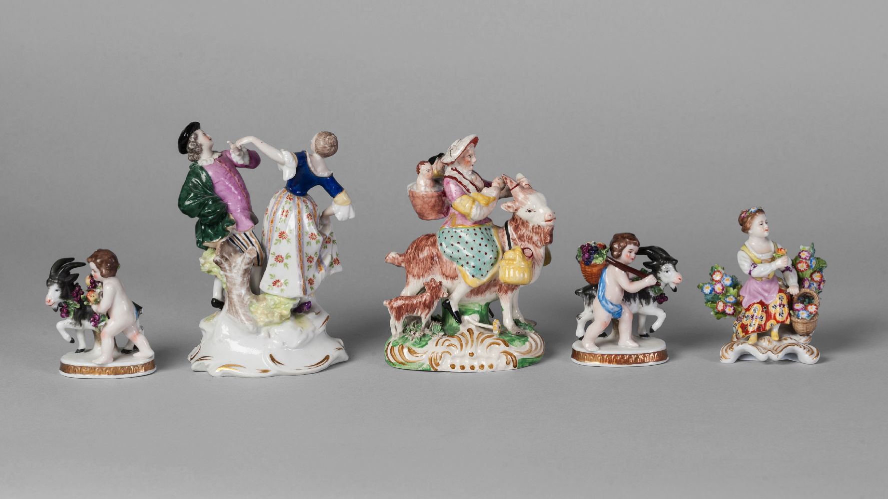 A pair of Continental porcelain figure groups of cherubs and goats, probably Samson, late 19th/