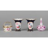 A pair of English porcelain miniature vases, 19th century, painted with reserves of flowers within