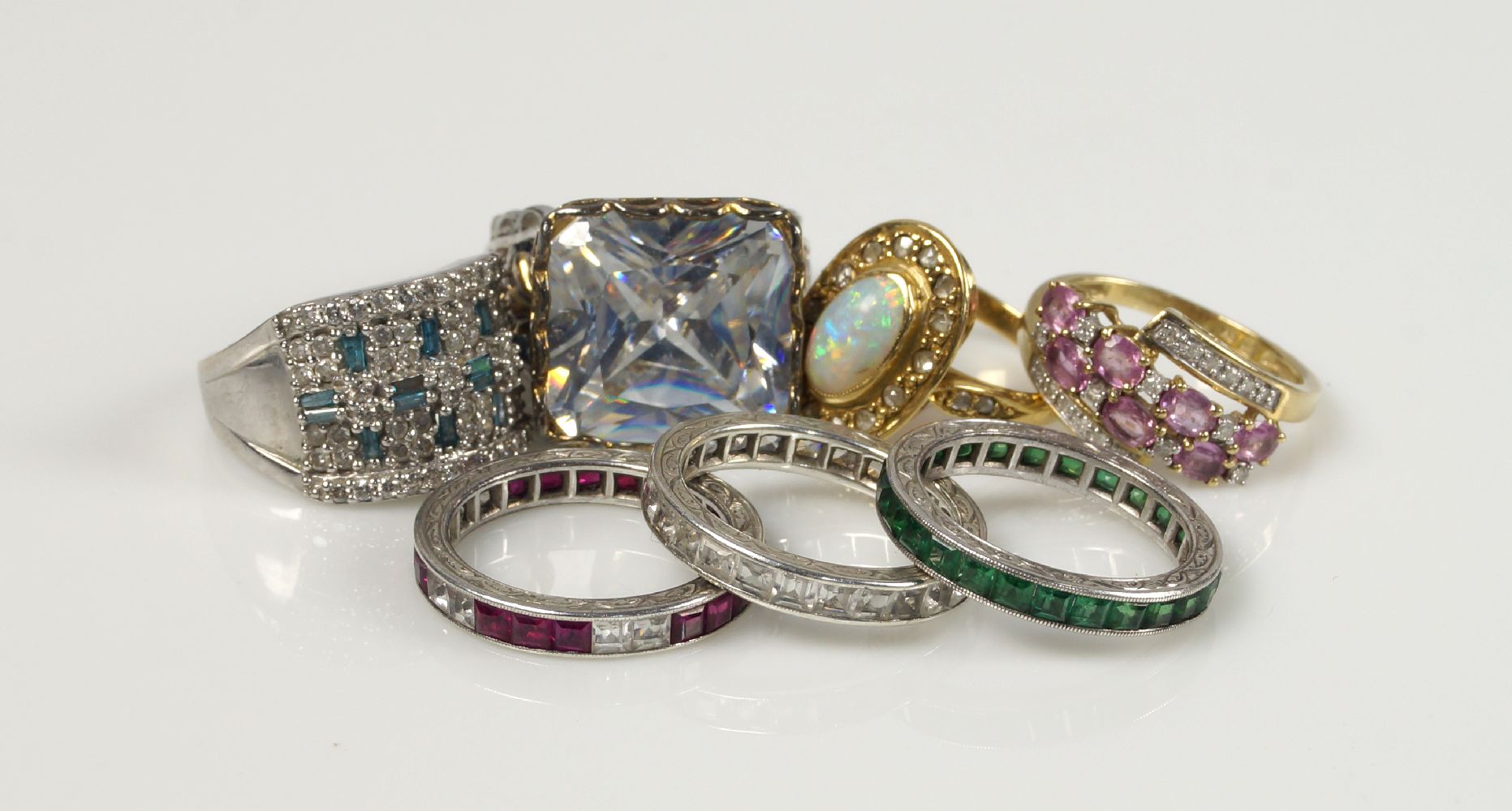 Including: a 9ct. gold, diamond and synthetic blue gem rectangular cluster half-hoop ring, an oval