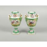 A pair of Continental porcelain double rams head handled vases, in the English manner, possibly