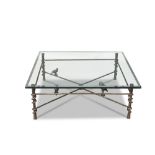 A patinated iron and bevelled glass low table in the manner of Diego GiacomettiModernThe square