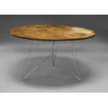 A contemporary walnut breakfast table, the top surface with drilled holes in varying sizes, on