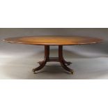A pair of Regency style mahogany circular extending dining tables, 20th Century, each with five