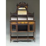 An Edwardian mahogany and marquetry inlaid side cabinet, the top with broken pediment and urn