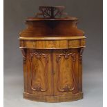 A Victorian mahogany corner cupboard, the shaped and pierced back with single shelf, above one