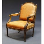 A Louis XV style walnut fauteuil, late 19th, early 20th Century, upholstered in orange fabric, the