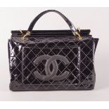 A Chanel large black patent handbag, two external pockets with black leather CC logo to one, two