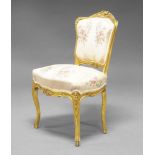 A French Louis XV style giltwood salon chair, 20th Century, the gilt frame with carved foliate and