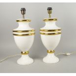 A pair of Tomasso Baubi urn shaped pottery lamp bases, 20th century, with gilt ring decoration to