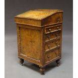 A Victorian oak Davenport, the fall front inset with leather, opening to reveal fitted interior,