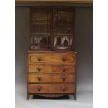 A Victorian secretaire bookcase, the top section with two astragal glazed doors enclosing three