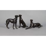 Three bronzed metal models of grey hounds, late 20th century, 16cm high (3)