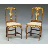 A pair of Continental walnut and ivory inlaid side chairs, 19th Century, decorated with putti,