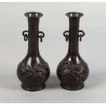 A pair of Japanese miniature bronze bottle vases, late 19th century, with ring handles, moulded to