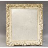 A continental style white painted mirror, of recent manufacture, with floral moulded decoration,