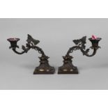 A pair of Regency bronze single candle sticks, with pierced foliate cast branches terminating in