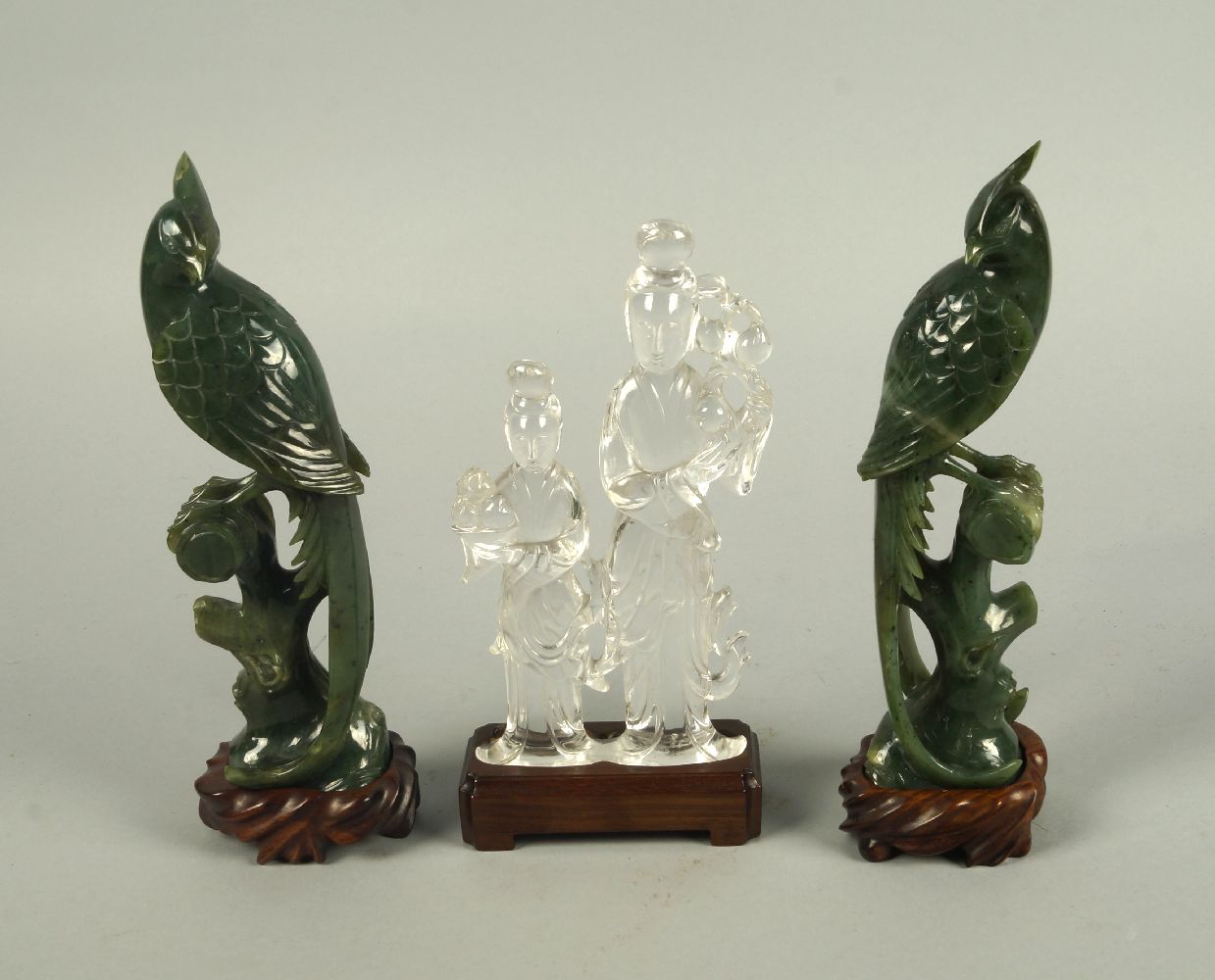 A Chinese rock crystal carving of two ladies, 20th century, modelled holding lotus branches and