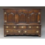A George III oak mule chest, adapted to have pair of cupboard doors above arrangement of five