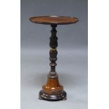 A Continental mahogany occasional table, 19th Century, the circular top, above central foliate