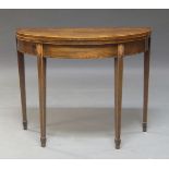 A George III mahogany and inlaid foldover card table, on square tapering supports to spade feet,