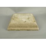 A carved stone plinth, possibly Bath stone, 10cm high x 38cm square