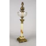 An oil lamp, late 19th/early 20th century, with an onyx column, on a stepped leaf moulded base