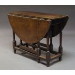 An oak gate-leg table, late 18th century, the circular top on turned and block supports, 100cm wide,