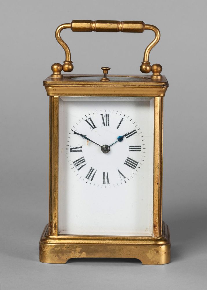 A French gilt brass carriage clock, 20th century, with a loop handle, the white enamel dial with