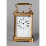 A French gilt brass carriage clock, 20th century, with a loop handle, the white enamel dial with