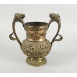A Tibetan copper twin handled vase, 19th/20th century, the handles mounted with beasts masks, the