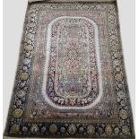 A Turkish silk rug with rounded rectangular main field panel, 166 x 101 cm and a silk prayer rug