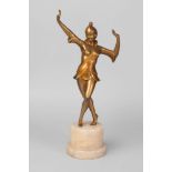 An Art Deco bronzed spelter figure of a dancing girl, on a pale pink alabaster column base, 37cm