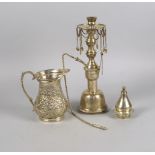 A Middle Eastern silver jug, 20th century, with scroll form handle, the body worked with flower