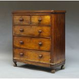 A Victorian mahogany chest of drawers, with two short over three drawers, raised on bun feet,