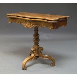 A French walnut foldover card table, 19th century, the shaped top above baluster central column to