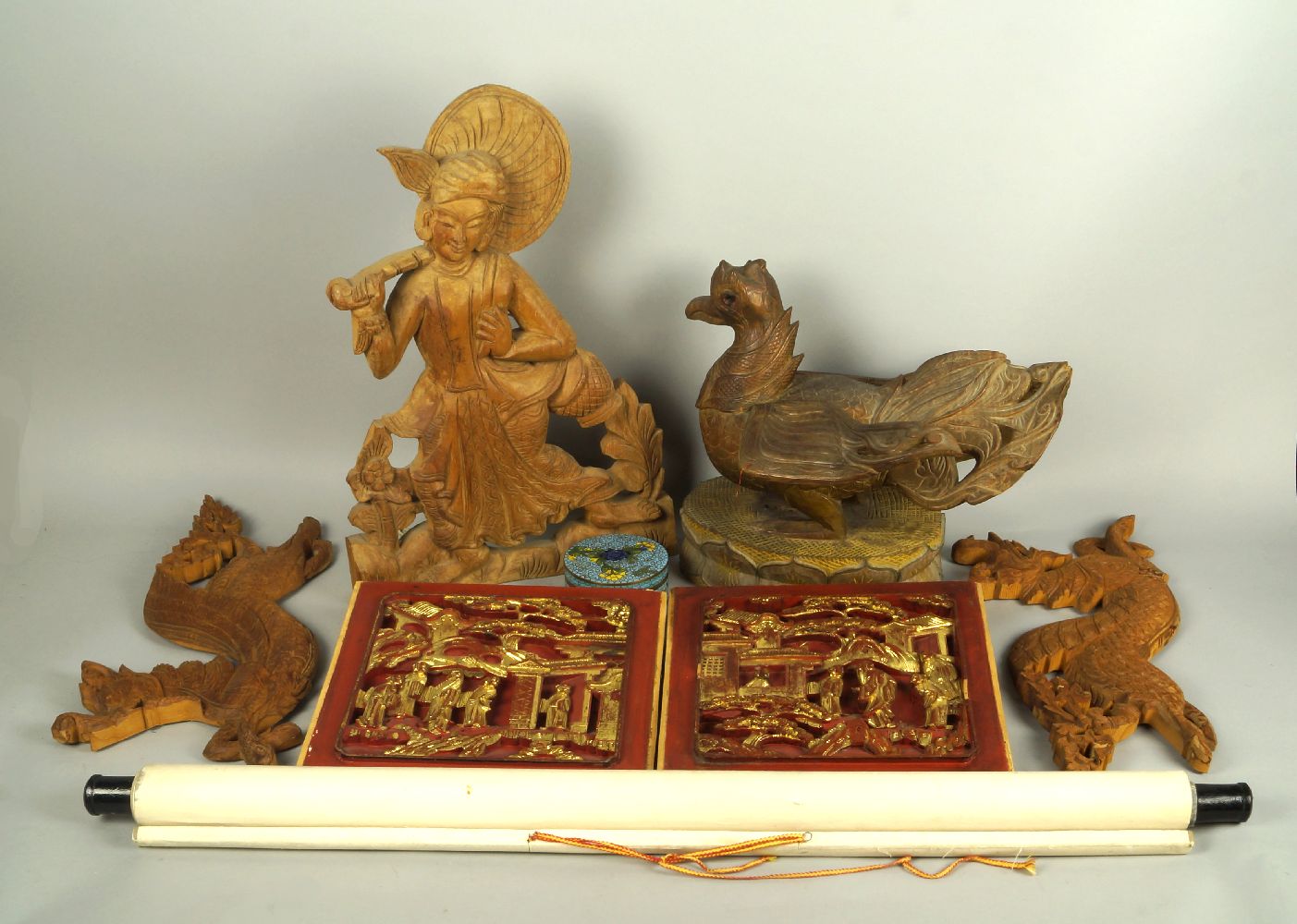 A set of four Indonesian carvings, to include a large bird, 31cm high, a pair of plaques of mythical