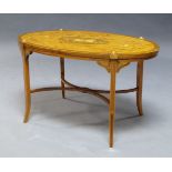 An Edwardian satinwood and marquetry inlaid occasional table, the oval top inlaid with foliate