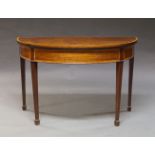 A mahogany and cross banded demi lune card table, late 19th, early 20th Century, the fold over top