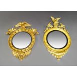 Two Regency gilt wood mirrors, each mounted with an eagle cresting on rocky outcrops, the circular