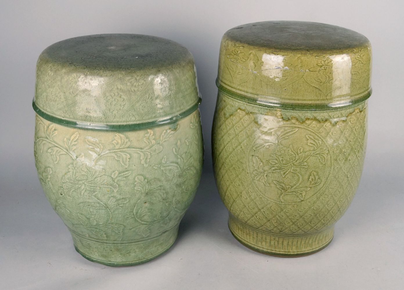 Two Chinese celadon glazed garden seats, late 20th century, with incised patterns of flowers and