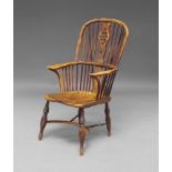 An elm and yew Windsor armchair, 19th Century, the high hoop back with wheel and heart motif pierced