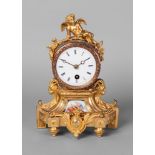A French gilt bronze and porcelain mounted mantel clock, 19th century, the case mounted with a