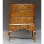 A George I oak chest on stand, the moulded cornice above six drawers, with shaped apron, on cabriole