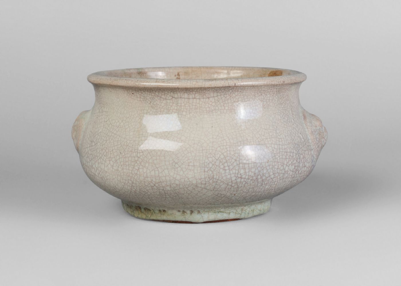 A Chinese white glazed stoneware censer, Qianlong period, of circular bombe form, moulded with