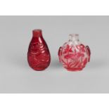 Two Chinese glass snuff bottles, late Qing dynasty, one cameo carved with lotus, 6cm high, the other