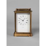 A brass carriage clock by Benzie, Cowes, 20th century, the white enamel dial with Roman numeral