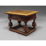 A German oak centre table, 17th century, the mitred panelled top on slide opening to reveal fitted