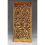 A Spanish walnut and ebonised door, 19th Century, overall applied with geometric moulding, 200cm x