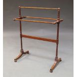 A Victorian mahogany towel rail, with turned supports, to out swept legs, on bun feet 92cm high x